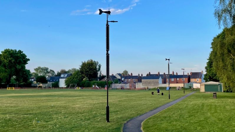 Oxford Road Recreation Ground, Littlemore A park scene featuring a pathway, grassy area, and a backdrop of buildings and trees.