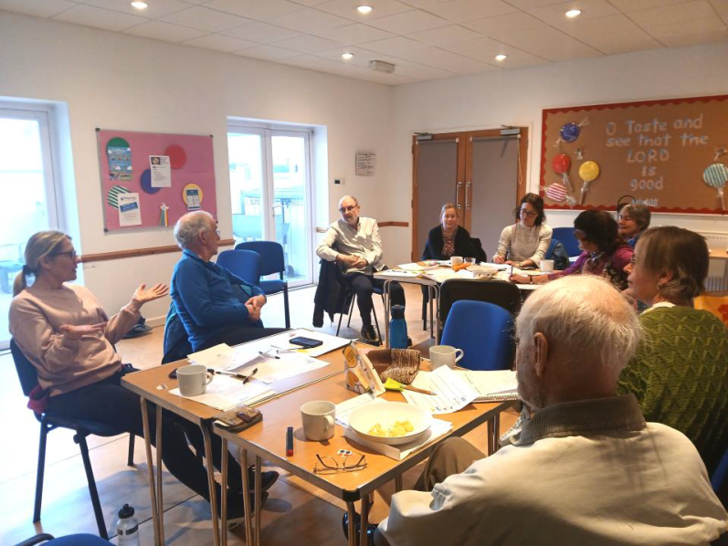 Wallingford Flowers of Proximity workshop, 2025 A group of people engaged in discussion around a table with food.